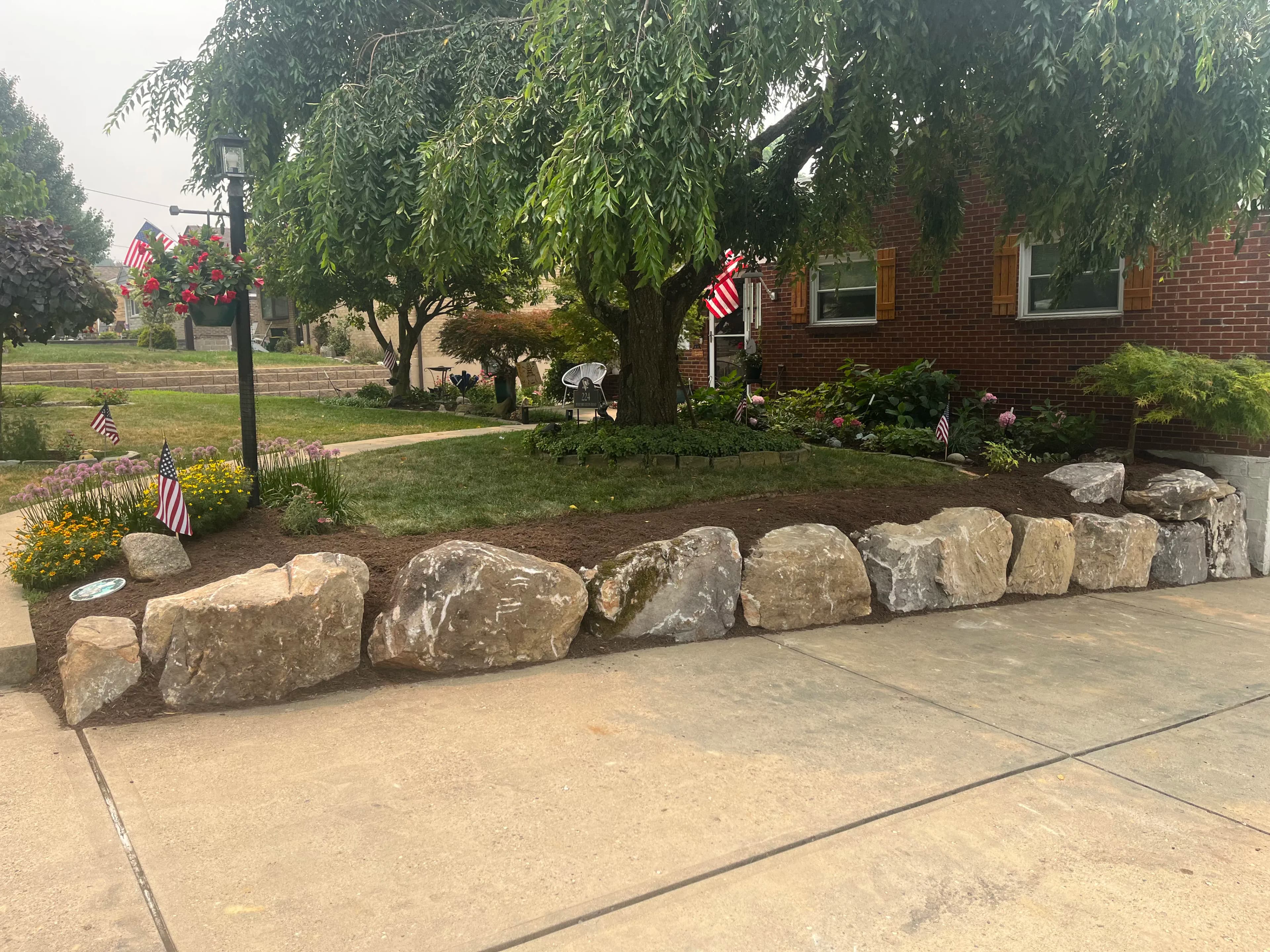 Project Boulder Wall and Fresh Mulch Give This Front Bed a Sharp New Edge image