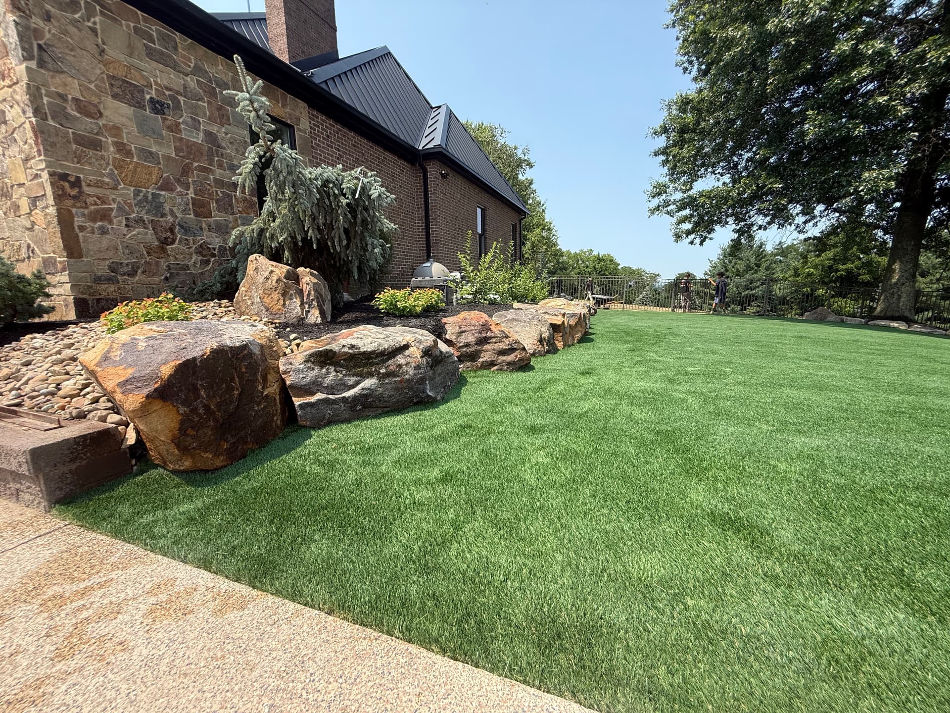 Turf Install and Boulder Landscape Design That Actually Holds Up
